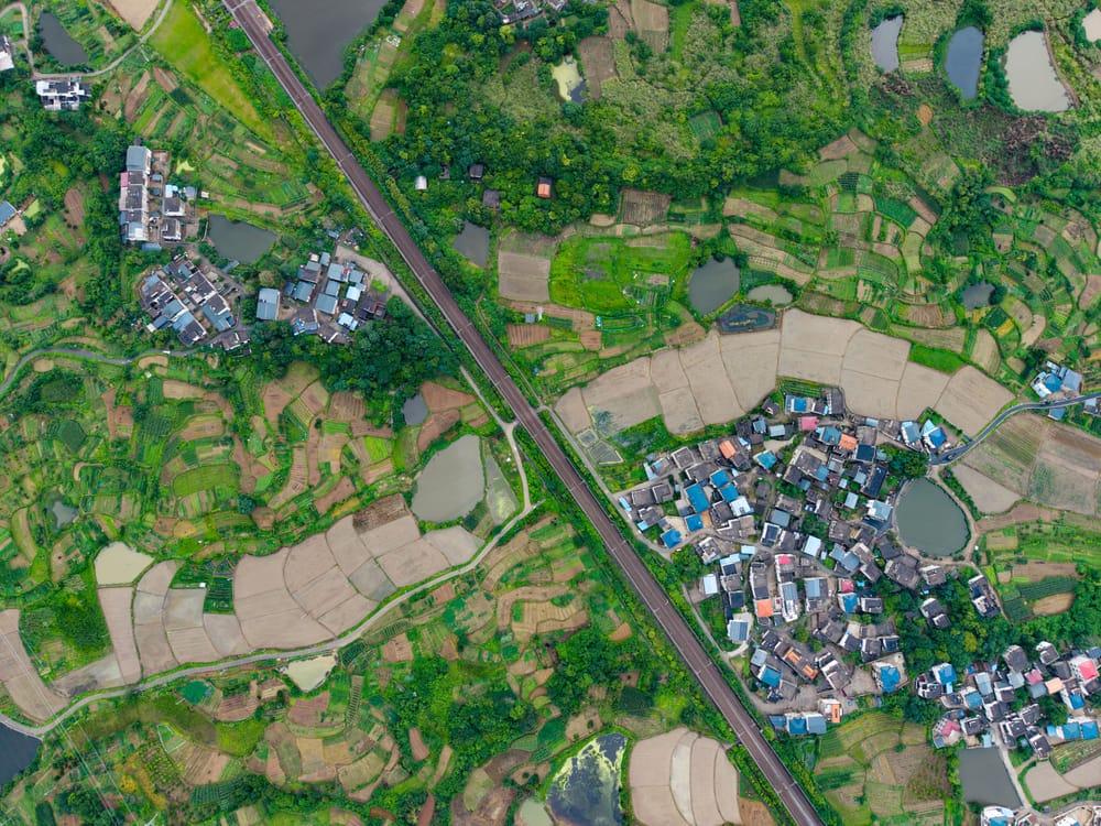 Aerial view of farmland, a village and a railway line